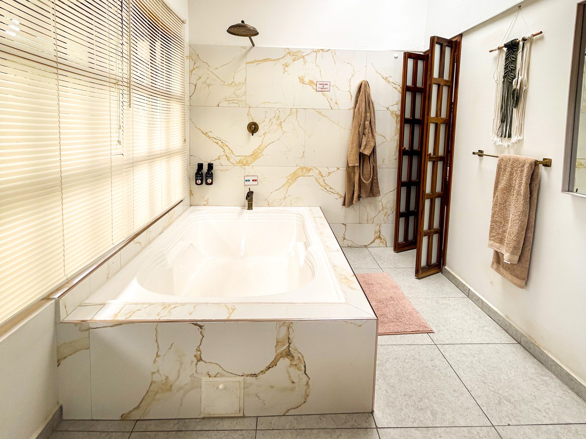 Baño de la Suite King con bañera de mármol y ducha en El Nido Andino, La Mesa